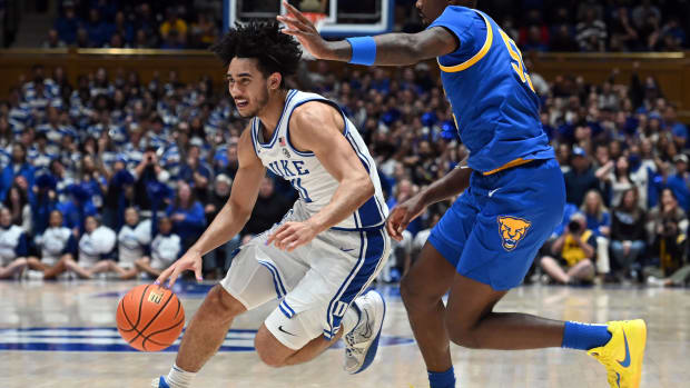 Duke Blue Devils guard Jared McCain dribbles past Pittsburgh Panthers defenders.